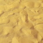 Close-up of golden sand textures at Punta del Diablo, ideal for backgrounds or natural texture visuals.